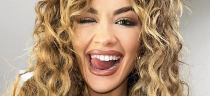 Rita-Ora-wink-1300.jpg Rita Ora Celebrates McDonald's In Tight Braless Minidress