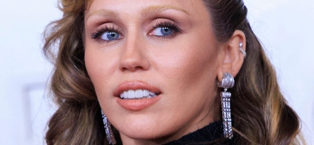 Miley Cyrus Offers A Mirror View In Only Jeans And Boots