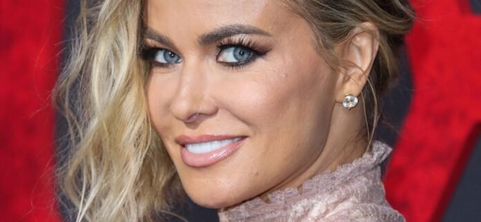 Carmen Electra Lifts Shirt With Nothing On Underneath