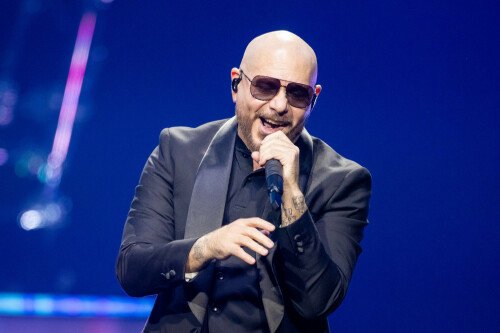 Pitbull says fans wearing bald caps to his concerts proves it's 'deeper than just music'