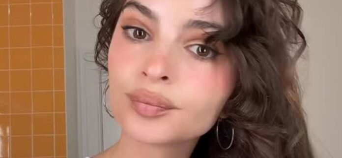 Emily Ratajkowski Sparks Complaints In Braless Minidress On Her Bed