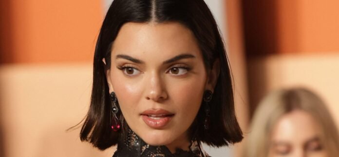 Fans Cry ‘Nice Try AI Kendall’ Over Jenner’s Ultra-Glossy Bikini And Boots Snap