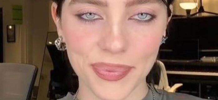 Billie-Eilish-eyeliner-1300-1.jpg Billie Eilish In Plunging Underwear Highlights Her 'Melons' In Bed