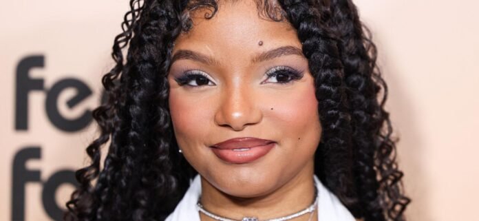 Halle Bailey Wrapped In Feather Stole Looks ‘Pregnant Again’