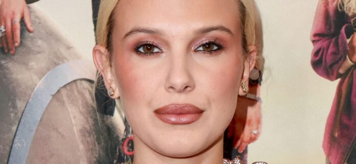 millie-bobby-brown-scaled-e1760022183874.jpg Millie Bobby Brown In Stringy Beach Bikini Is ‘Definitely An Eleven’