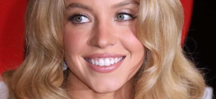 Sydney-Sweeney-side-hand-1300.jpg Sydney Sweeney 'Needs A Little Bra' In Totally Sheer Dress